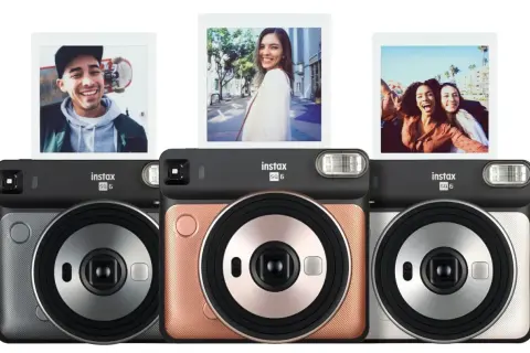 Aparat natychmiastowy Instax SQ6 w trzech kolorach: szarym, różowym i srebrnym. Nad aparatami widoczne są trzy zdjęcia zrobione tym modelem.