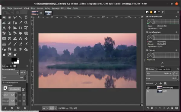 GIMP 2.10 z mglistym porannym krajobrazem nad jeziorem. Widok na narzędzia i panele programu.