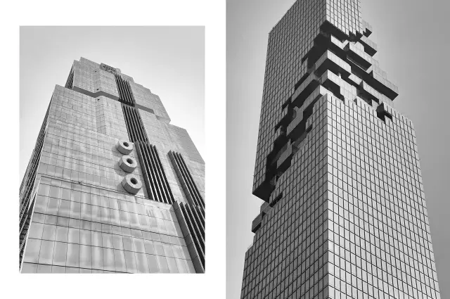 Dwa drapacze chmur widziane z dołu, ukazujące ich nowoczesną architekturę i fascynującą perspektywę.